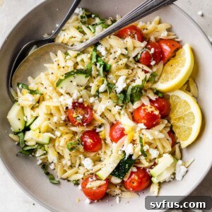 bowl with lemon orzo salad beside a small dish of chopped fresh basil