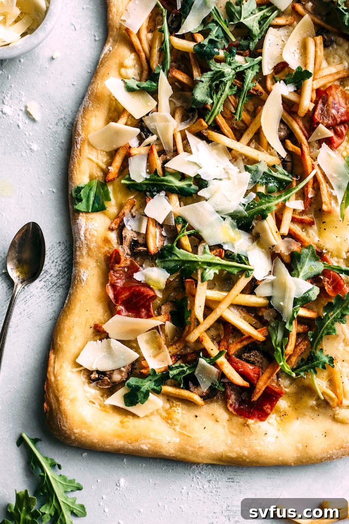Gourmet White Truffle Pizza with aromatic truffle oil and generous toppings, including crispy French fries