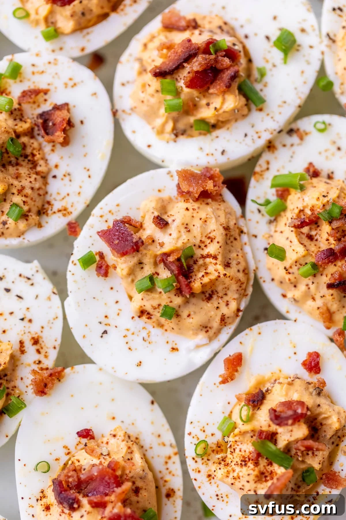 Chipotle Deviled Eggs topped with fresh chives, a bold and flavorful party appetizer