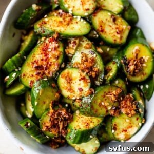sliced cucumbers in a bowl topped with chili flakes