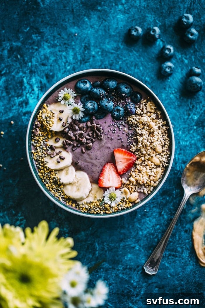 A close-up of a perfectly blended purple acai smoothie, smooth and thick, ready for a bowl and toppings.