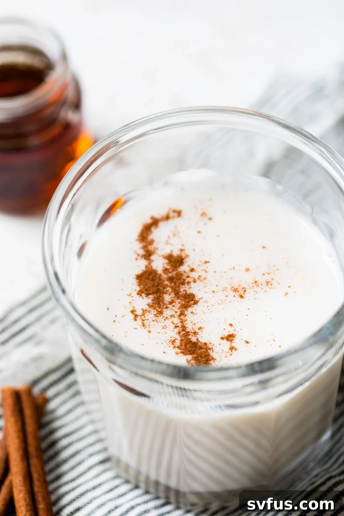glass of milk topped with cinnamon