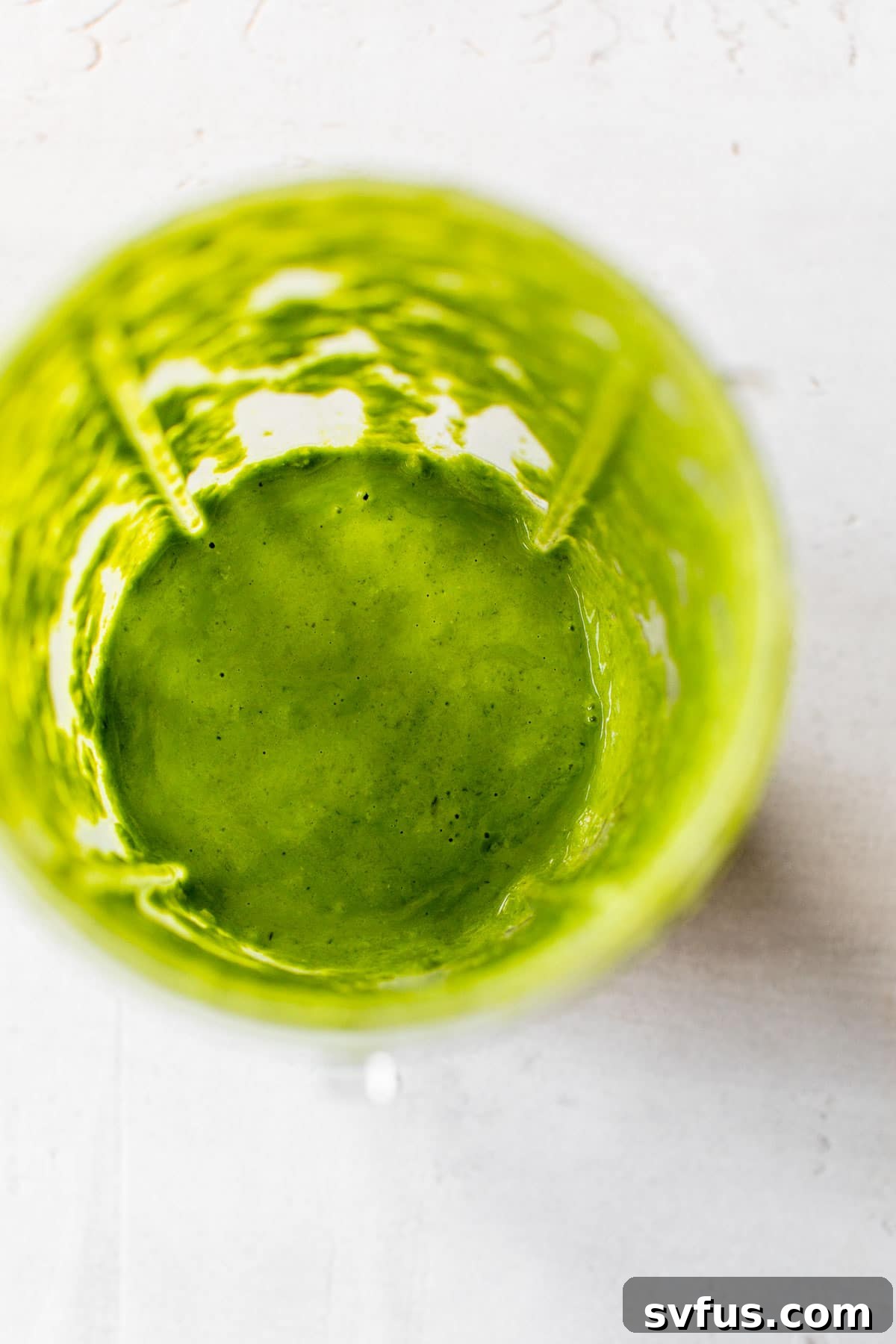 pesto in a small blender, showing the vibrant green color and creamy texture