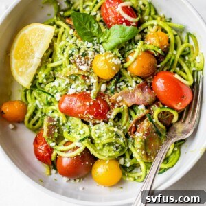 Pesto Zucchini Noodles in a bowl with tomatoes and bacon