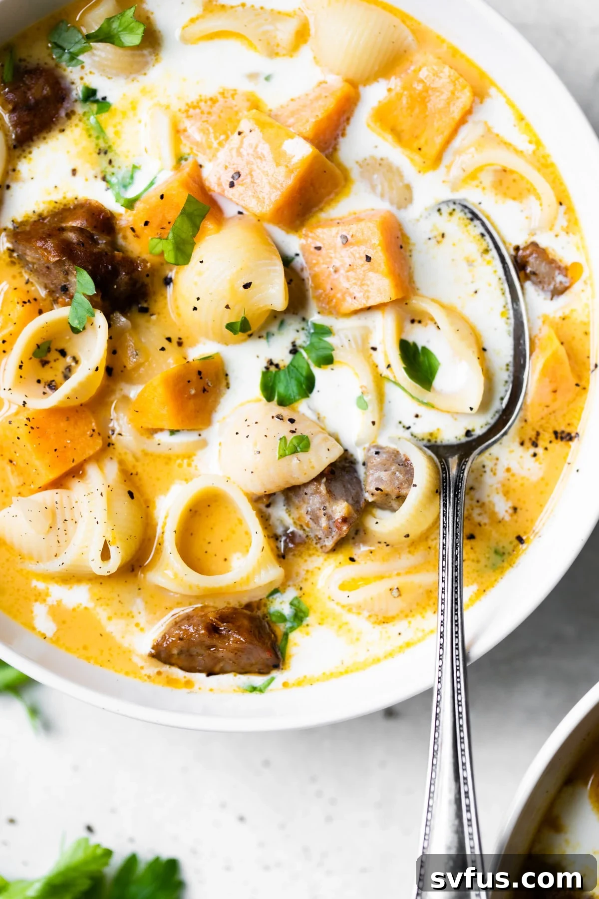 A comforting bowl of Chorizo Sweet Potato Soup with fresh herbs