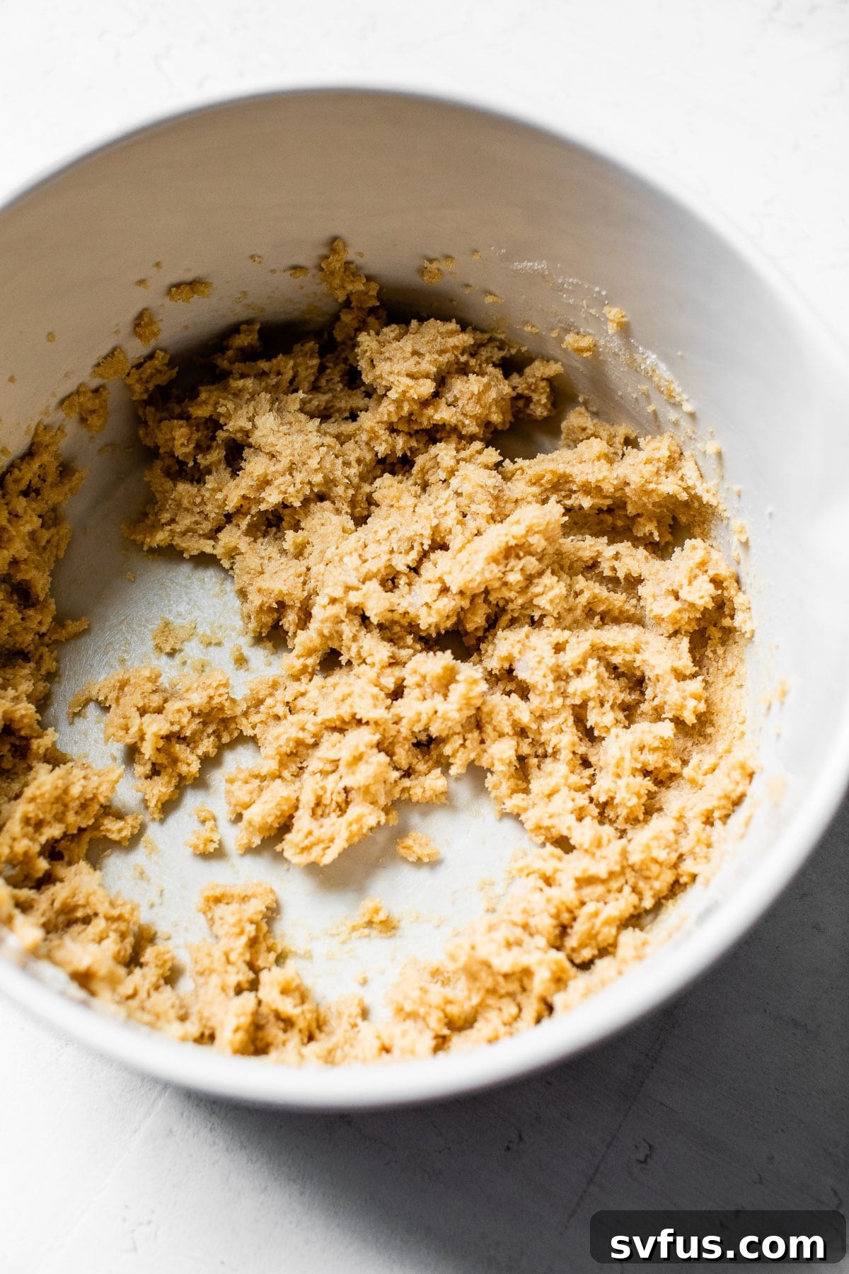Creamed vegan butter, coconut oil, and sugars in a mixing bowl, light and fluffy