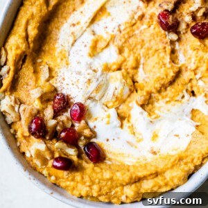 a bowl of hummus topped with nuts
