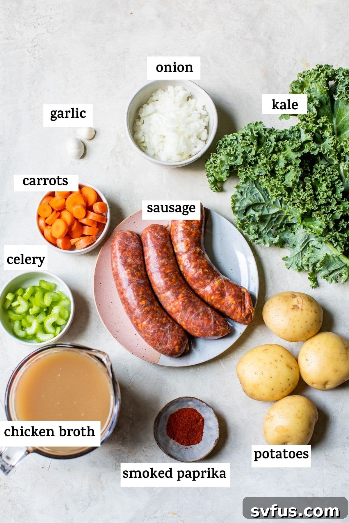Fresh ingredients laid out for Spicy Sausage Potato Soup, including vibrant kale, diced potatoes, aromatic spices, and savory sausage.