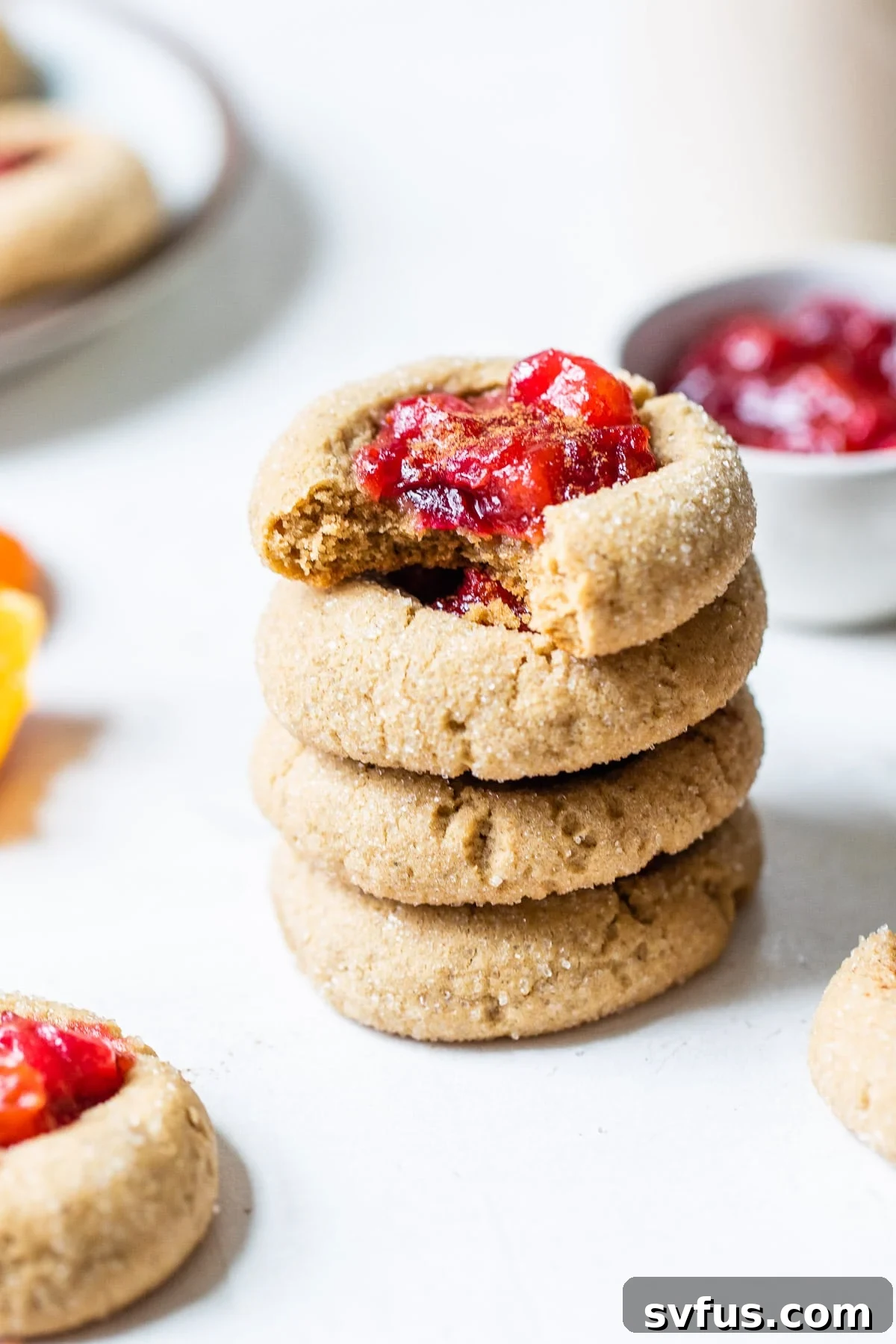 a stack of cranberry chai thumbprint cookies