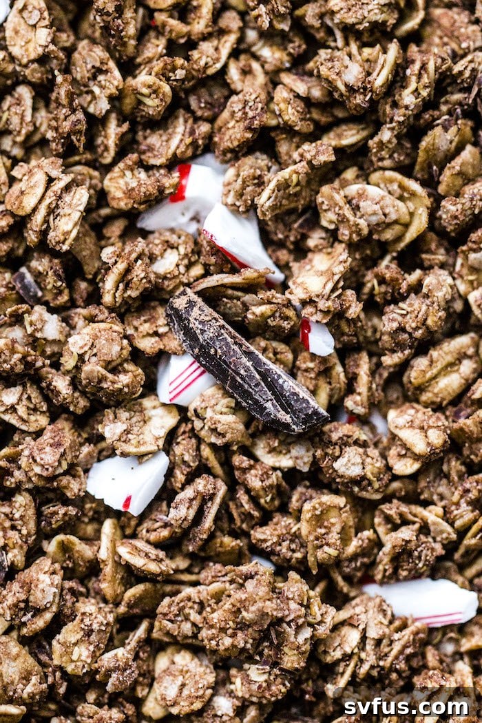 A bowl of chocolate peppermint granola mixed with yogurt for a parfait