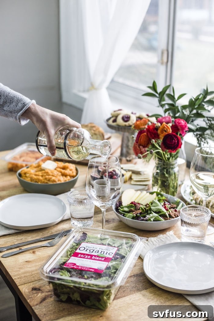 A beautifully decorated healthy holiday tablescape with butternut squash mash and apple pecan salad.