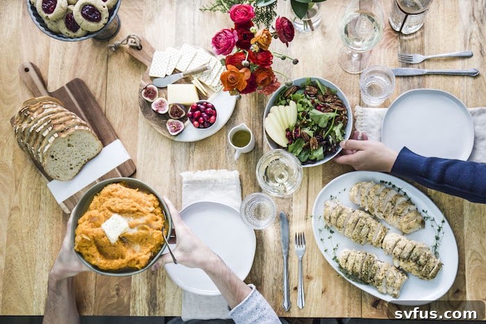 A selection of healthy appetizers including a cheese plate and bread on a holiday table.