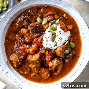 close up photo of a bowl of chili with beans and sausage