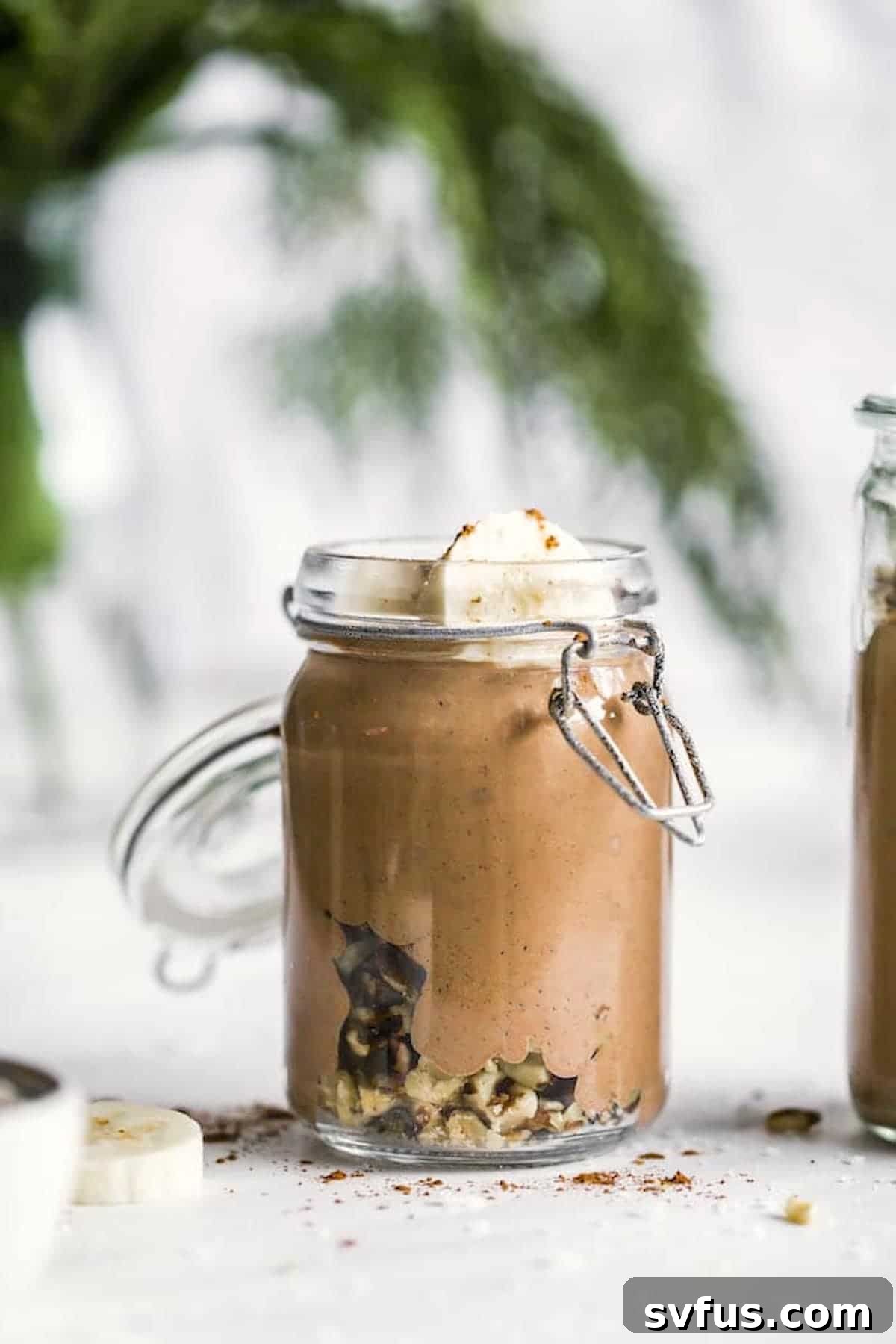 Delicious chocolate walnut smoothie with banana in a mason jar, garnished for a healthy, sweet breakfast