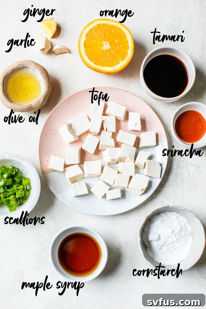 Collection of fresh ingredients for General Tso's Tofu laid out in small bowls on a wooden table