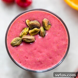 raspberry smoothie topped with pistachios