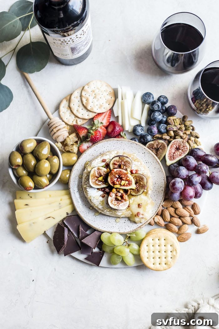 Summer Cheese Board Necessities, including a delicious baked brie topped with figs, pancetta and pistachios | thealmondeater.com