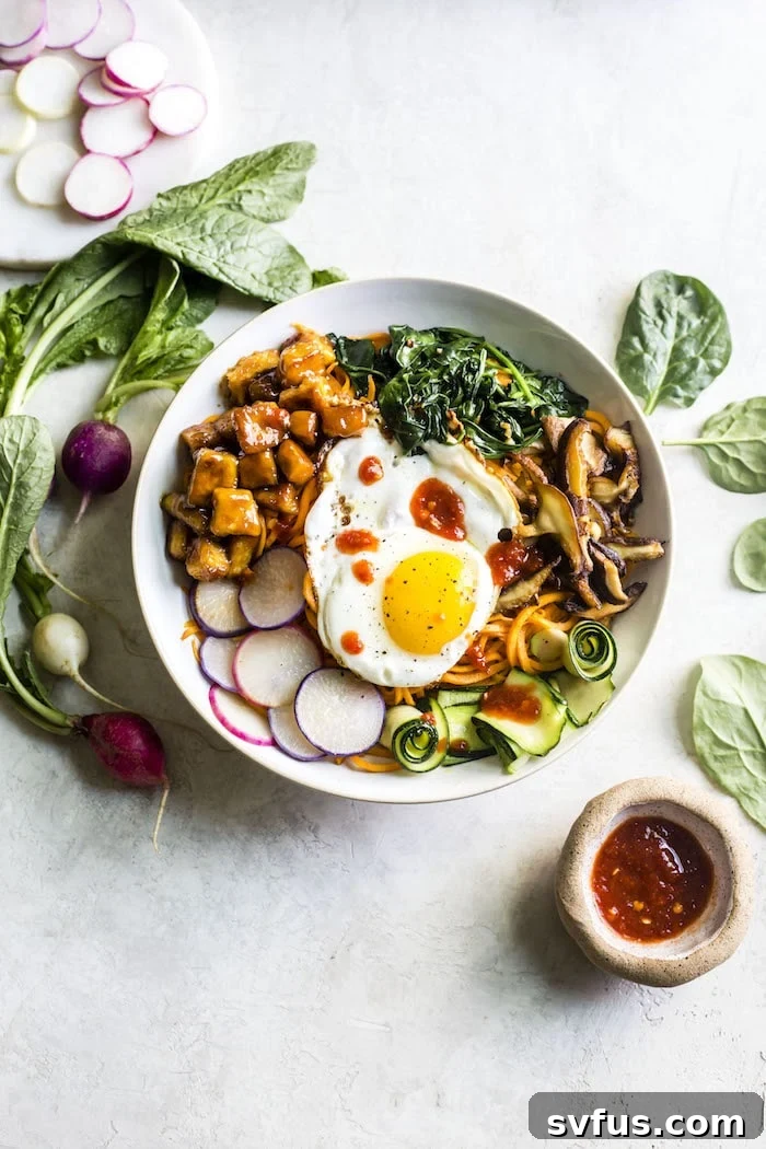 Delicious Tofu Sweet Potato Bibimbap with vibrant vegetables and a fried egg