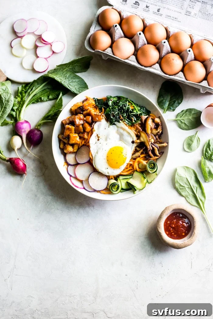 Close-up of Tofu Sweet Potato Bibimbap, showcasing the noodles and toppings