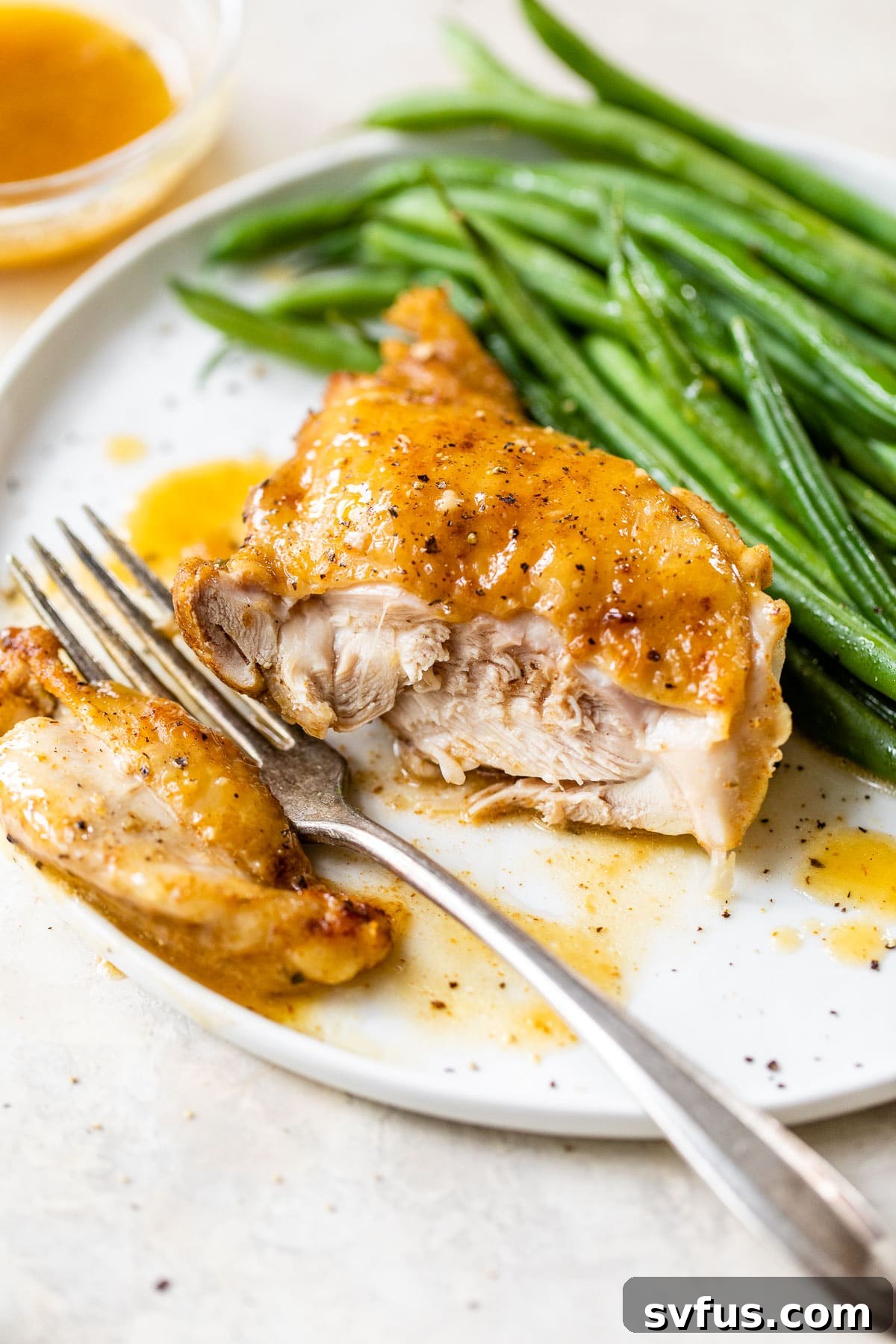 Cooked Instant Pot chicken thigh sliced open, showing its juicy interior