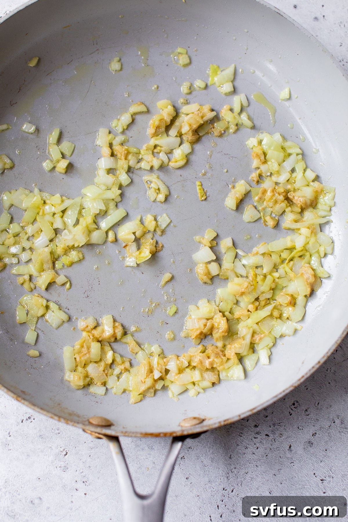 cooked diced onion and garlic in a skillet