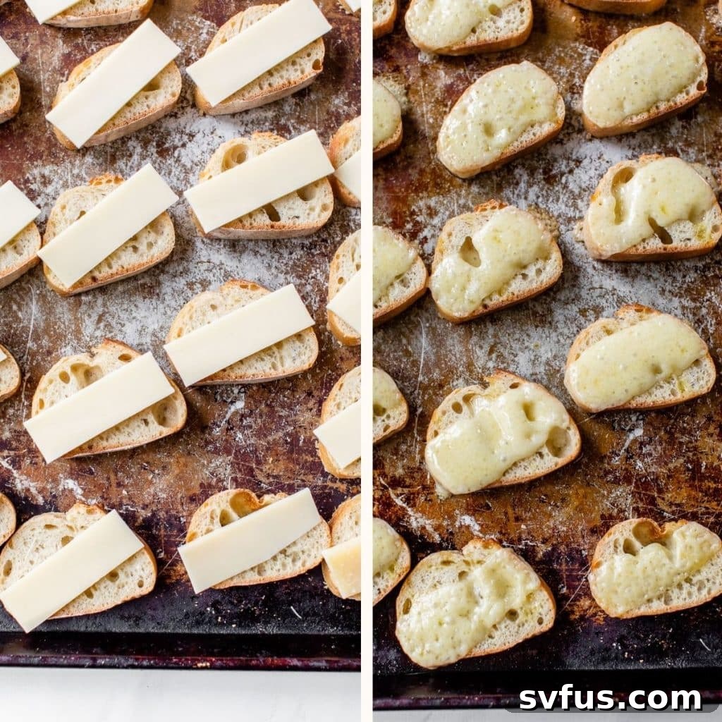 French baguette slices neatly arranged on a baking sheet, each topped with a generous slice of cheese, ready for the oven.