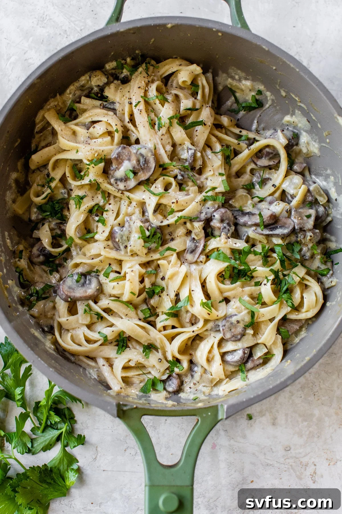 A large skillet filled with creamy vegan mushroom pasta, ready to be served, showcasing the rich sauce and tender mushrooms.