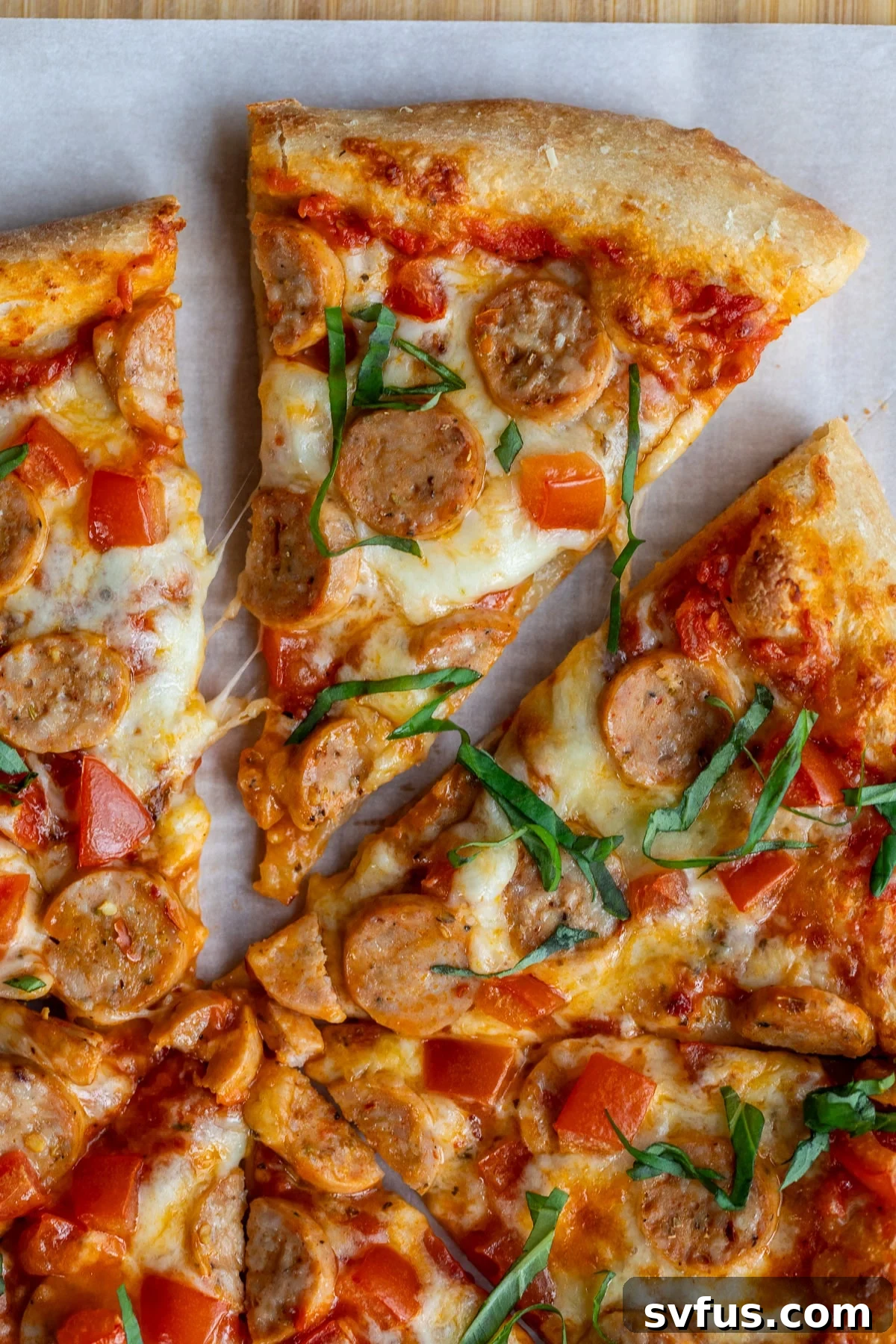 slice of chicken sausage pizza removed from the rest of the pizza