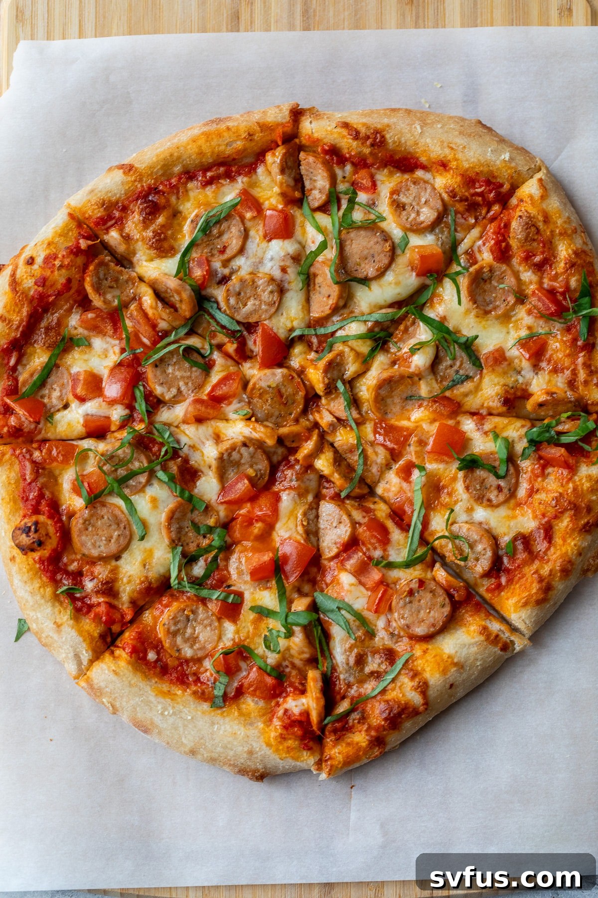 chicken sausage pizza sliced into 8 pieces