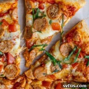 slice of chicken sausage pizza removed from the rest of the pizza
