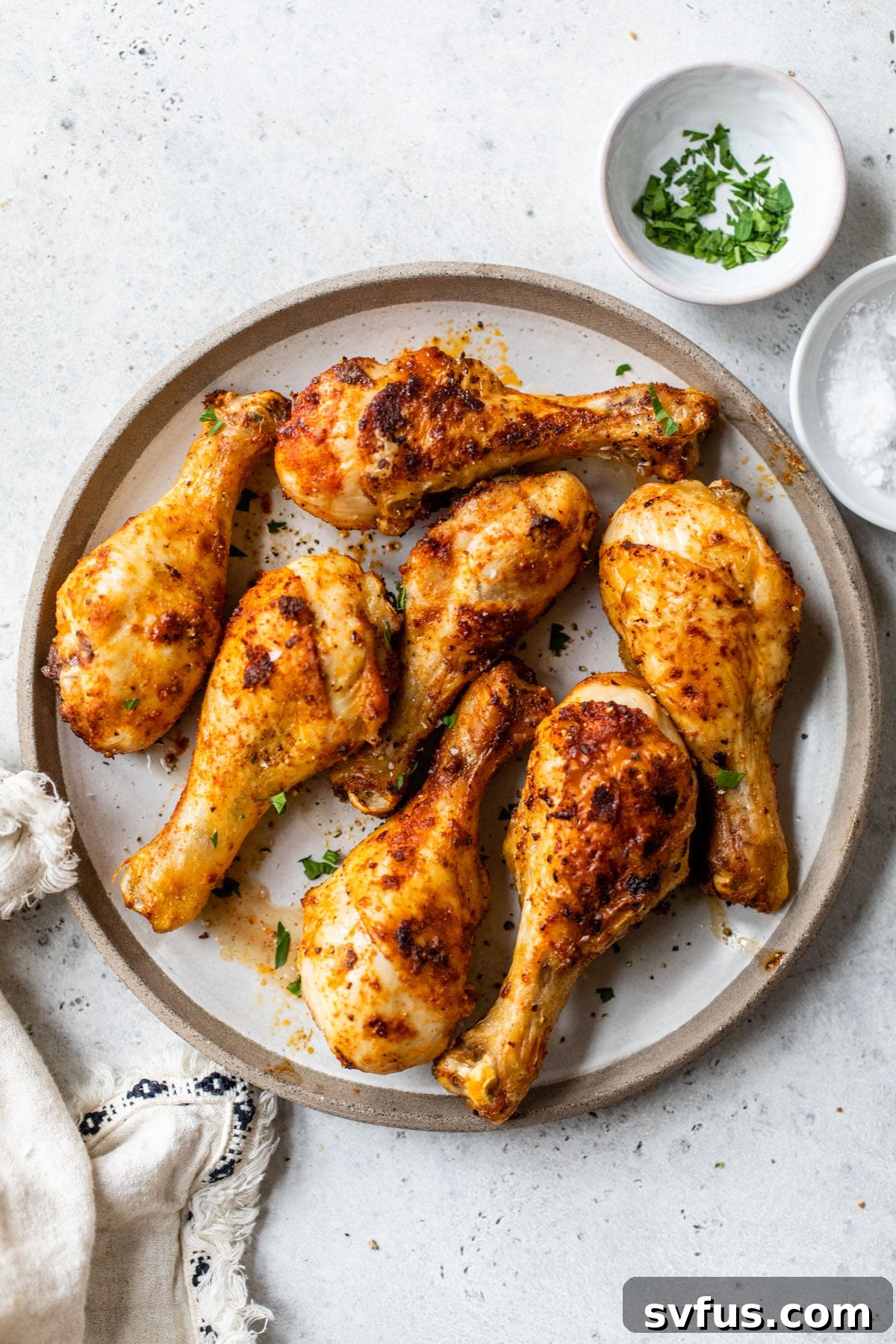 fried drumsticks on a plate beside a white linen