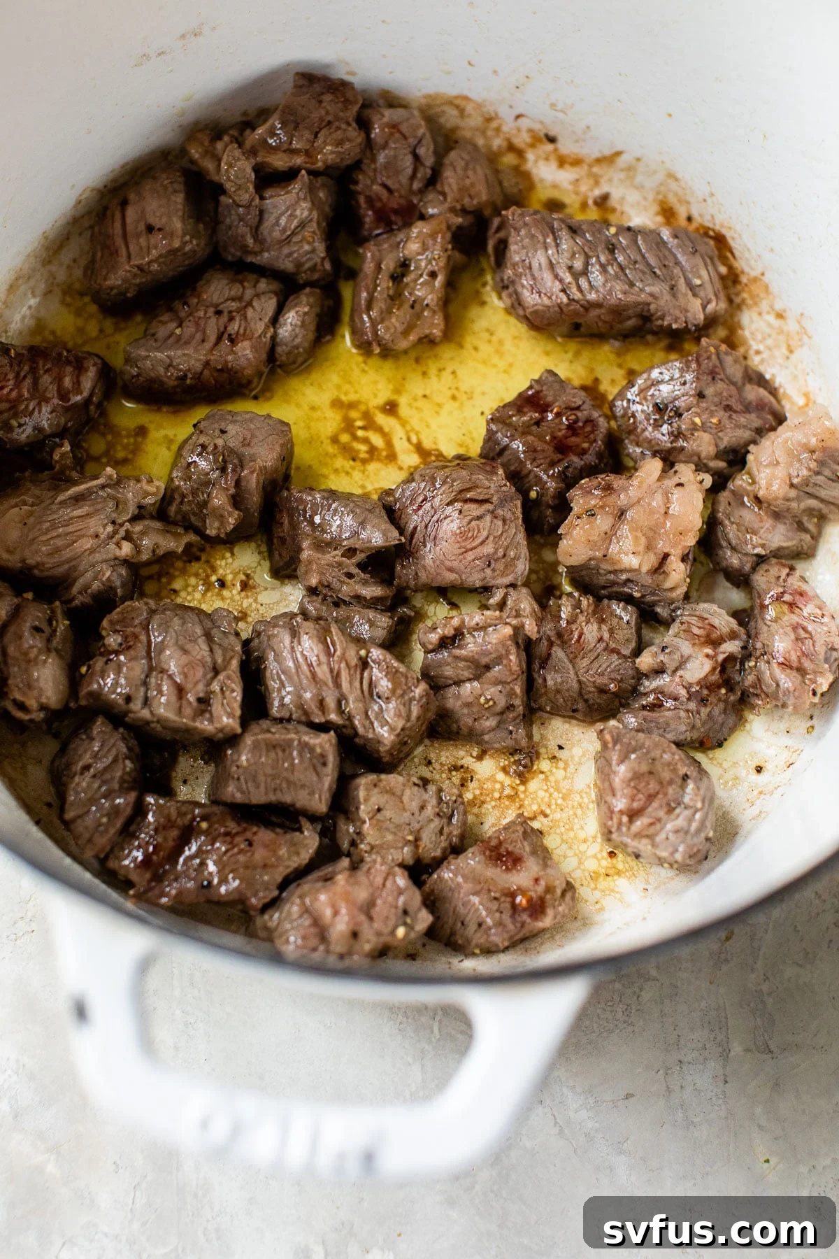 cooked beef stew chunks in a large pot