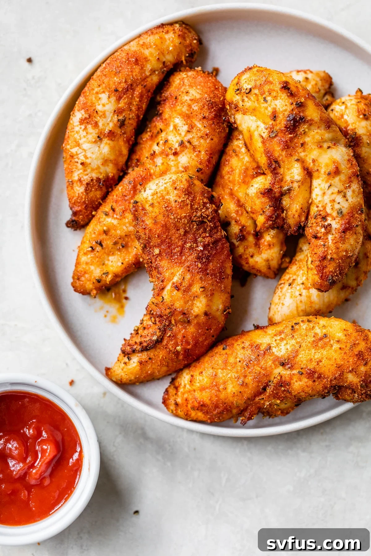 Crispy, perfectly cooked chicken tenders on a plate, ready to be served