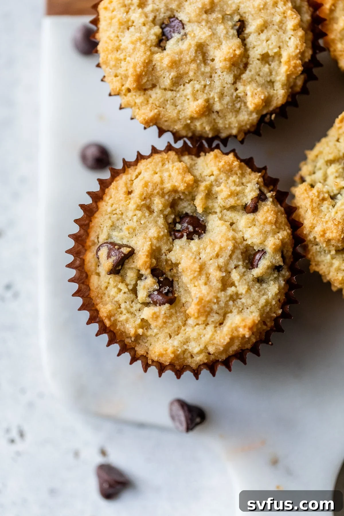 chocolate chip muffins on a marble cutting board