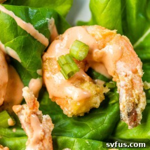 close up photo of fried shrimp in bang bang sauce