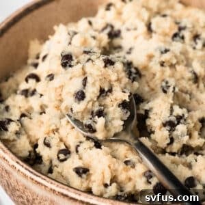 Close up on a spoonful of chocolate chip cottage cheese cookie dough in a bowl.