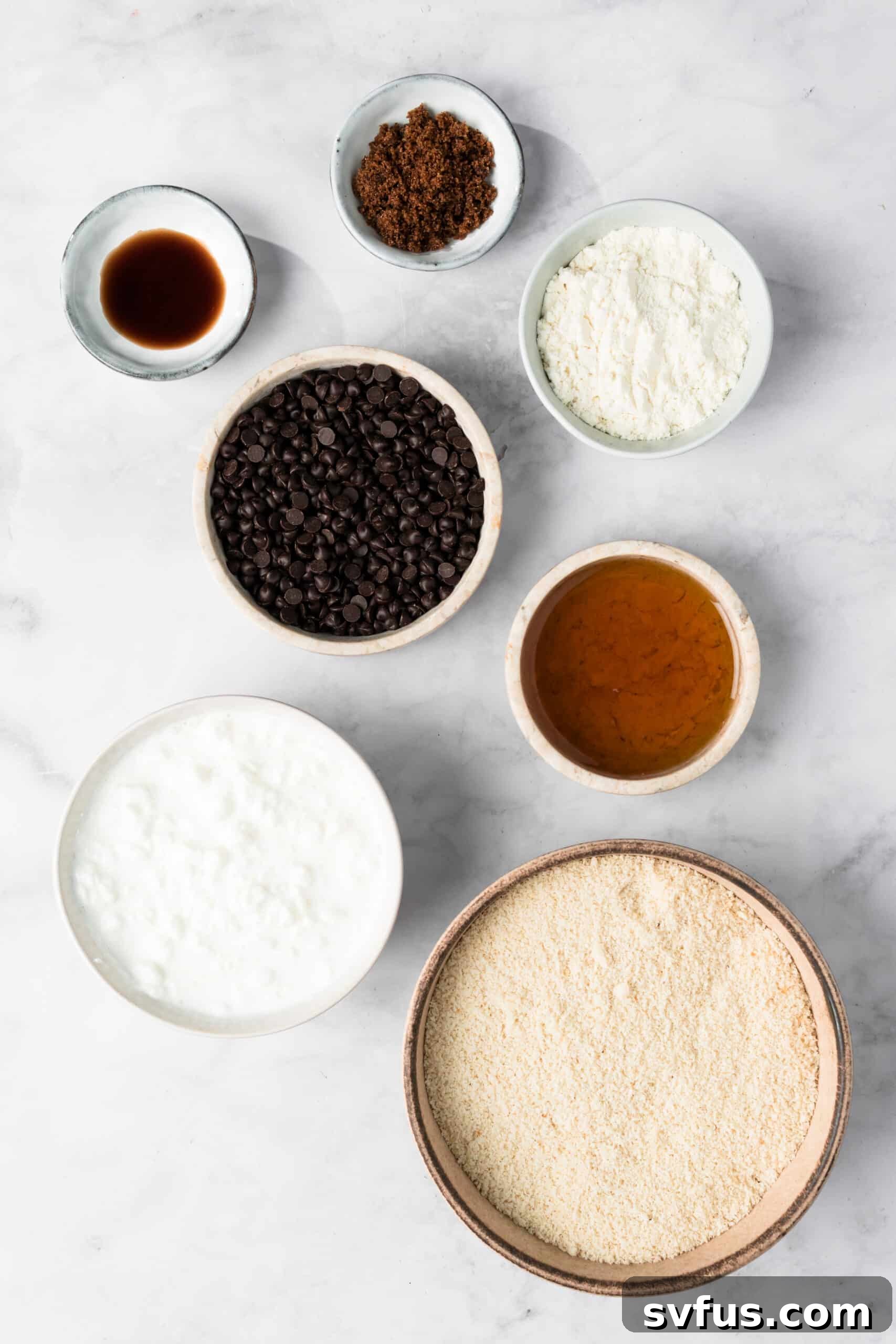 Overhead view of the ingredients for cottage cheese cookie dough in individual bowls.