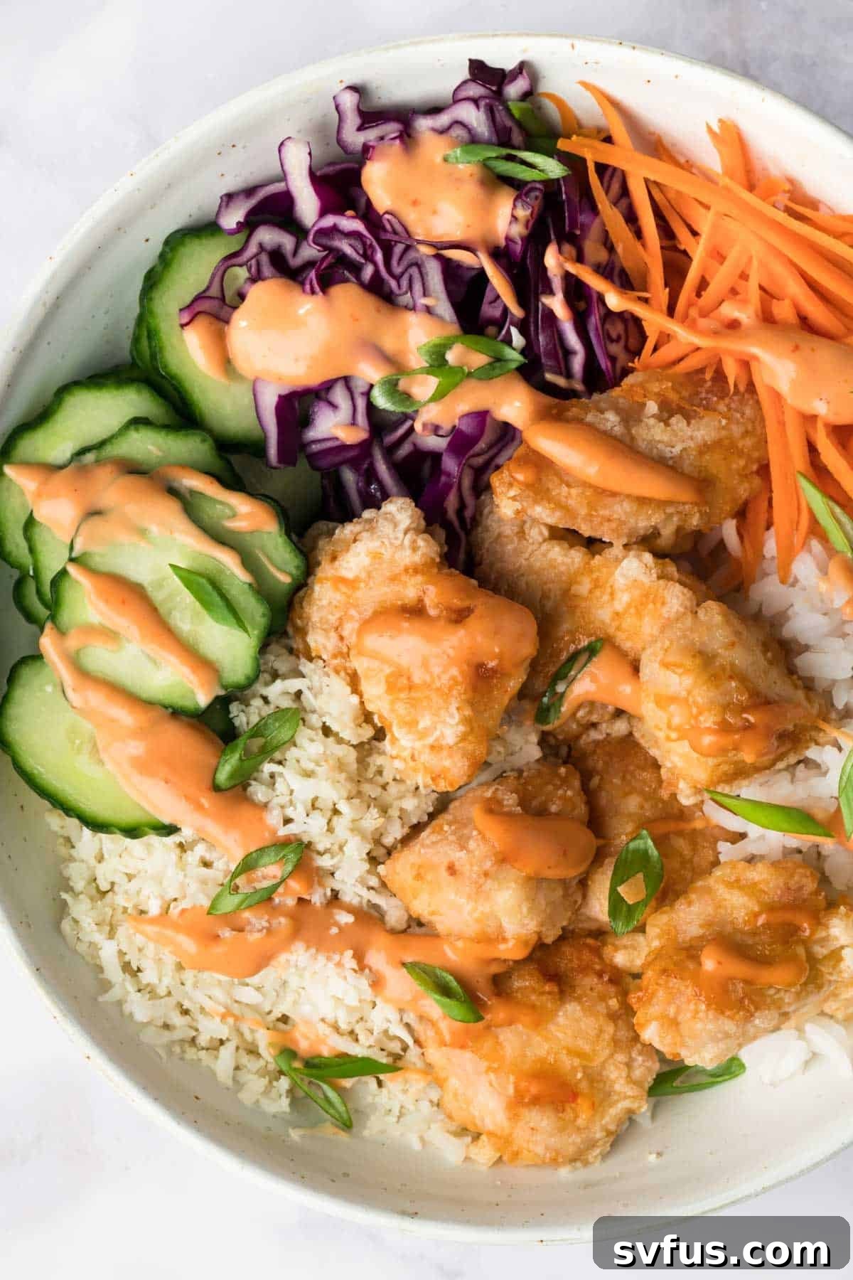 An inviting overhead view of a fully assembled Bang Bang Chicken Bowl, ready to be enjoyed.