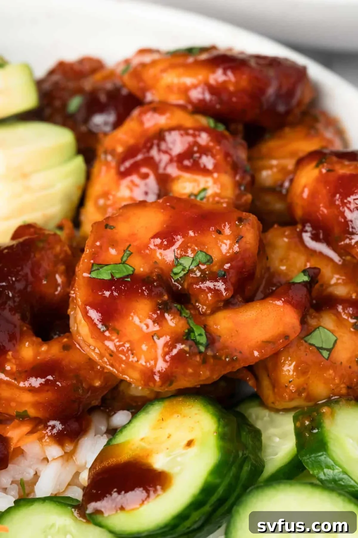 Close-up on the glistening BBQ shrimp, perfectly glazed, in a beautifully arranged BBQ shrimp bowl.