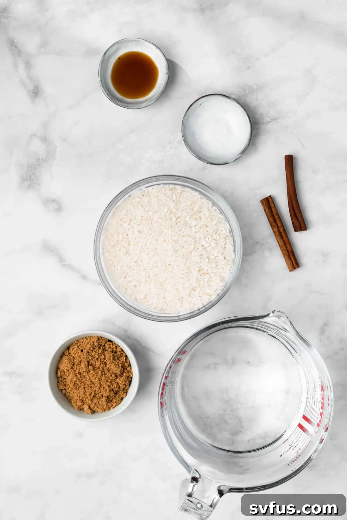 Overhead view of individual bowls holding the essential ingredients for homemade horchata: white rice, cinnamon sticks, and brown sugar.