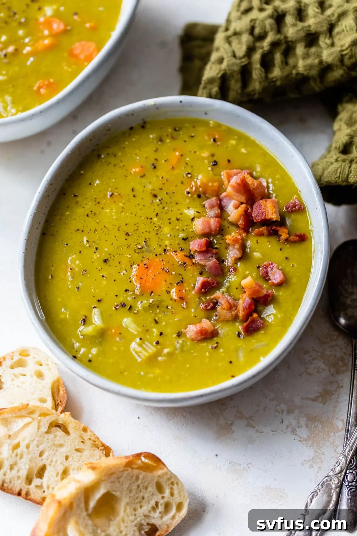 A bowl of Instant Pot Split Pea Soup, garnished with crispy pancetta pieces.