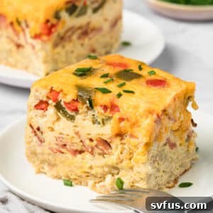 A delicious slice of Crockpot Breakfast Casserole on a plate, showcasing fluffy eggs and crispy hashbrowns.