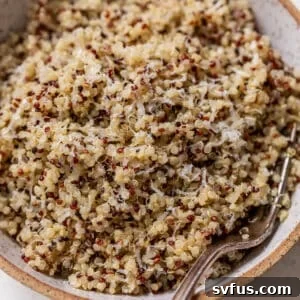 Overhead view of cooked quinoa in a bowl with a fork.