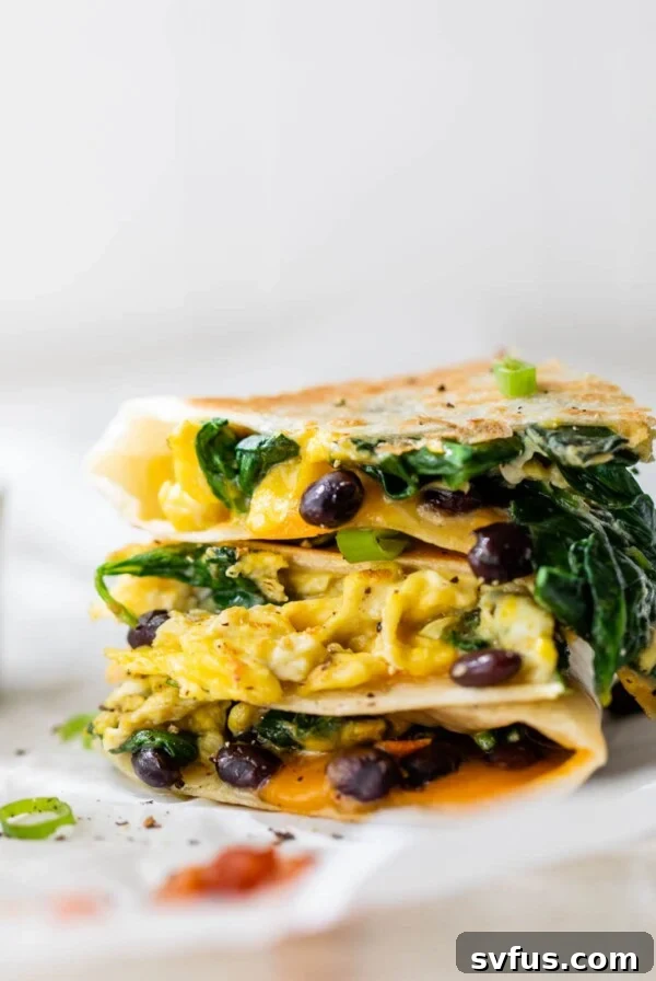 egg and black bean quesadilla stacked on parchment paper