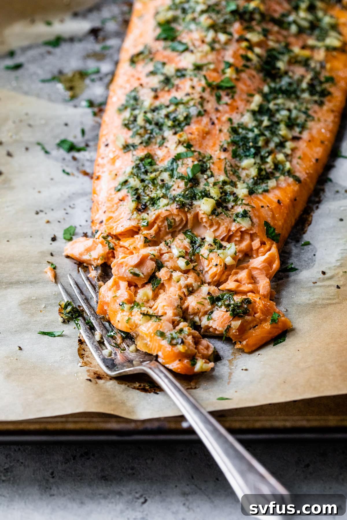 a fork flaking a piece of salmon