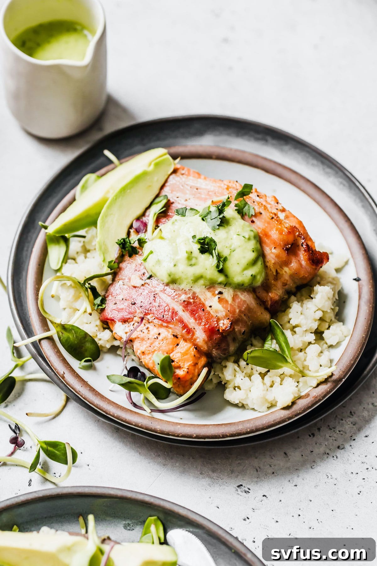 salmon on a plate with cauliflower rice