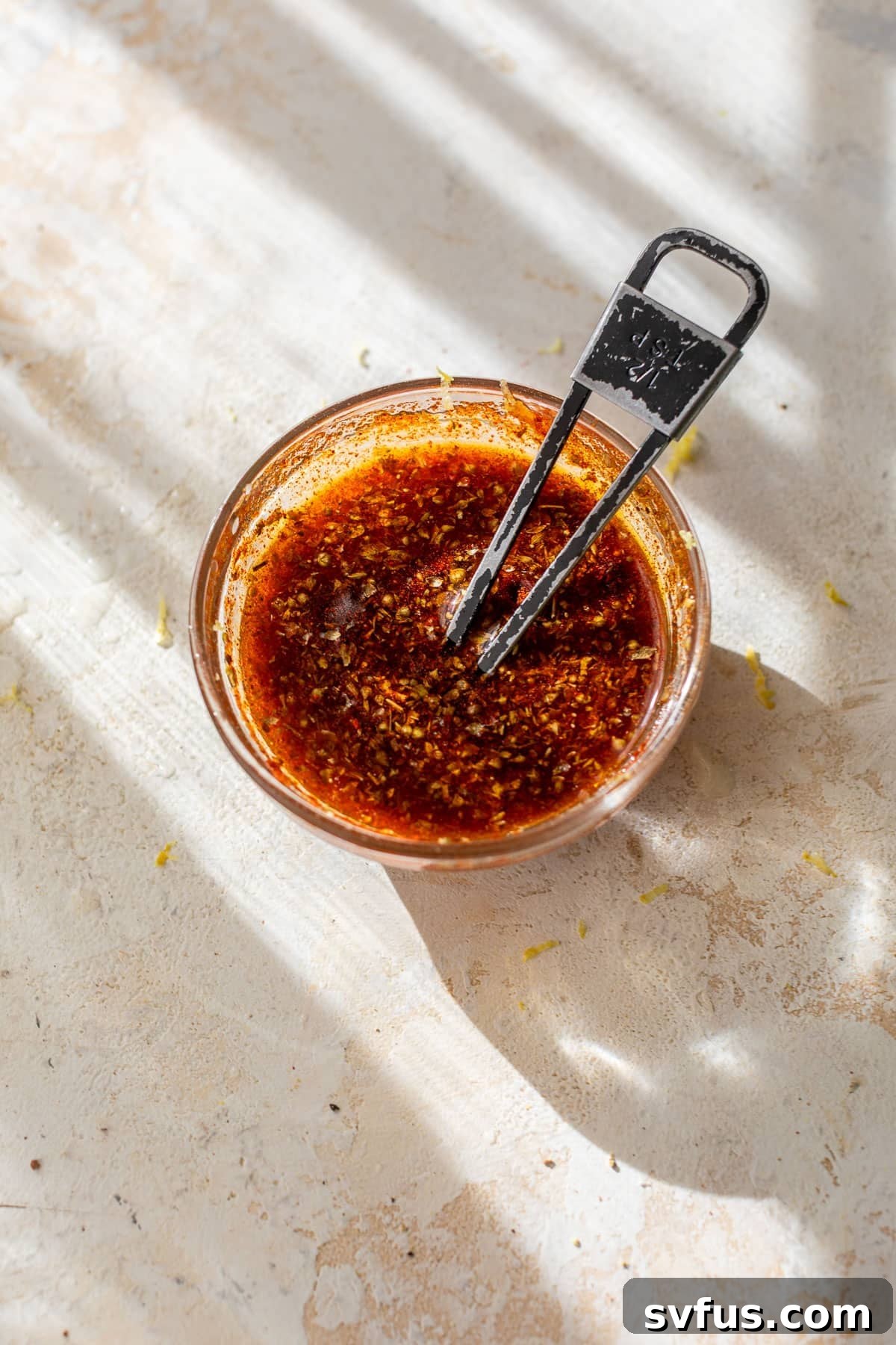 overhead view of a marinade for sheet pan salmon in a small bowl.
