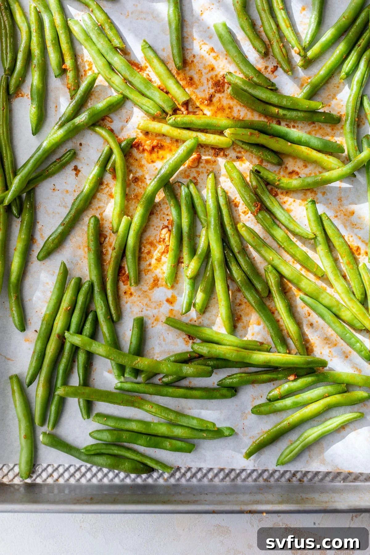 overhead view green beans on a sheet pan.