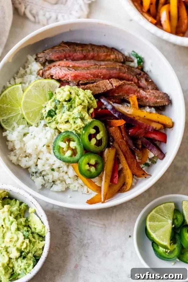 a bowl filled with cauliflower rice, steak, peppers, and guacamole