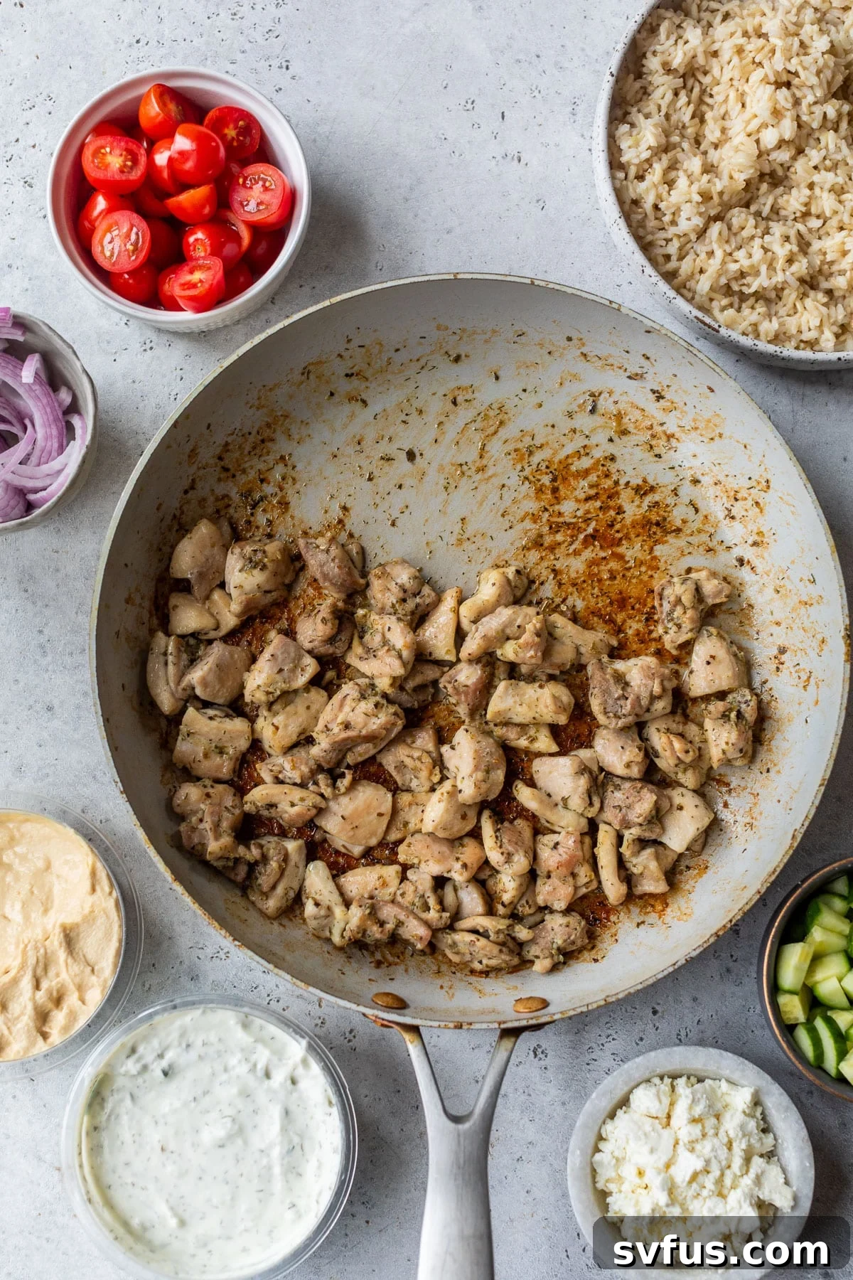 overhead view of the ingredients for Mediterranean Chicken Bowls in individual bowls.
